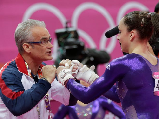 U.S. gymnast Jordyn Wieber, right, is greeted by head coach John Geddert during the Artistic Gymnastics women's qualification at the 2012 Summer Olympics, Sunday, July 29, 2012, in London.