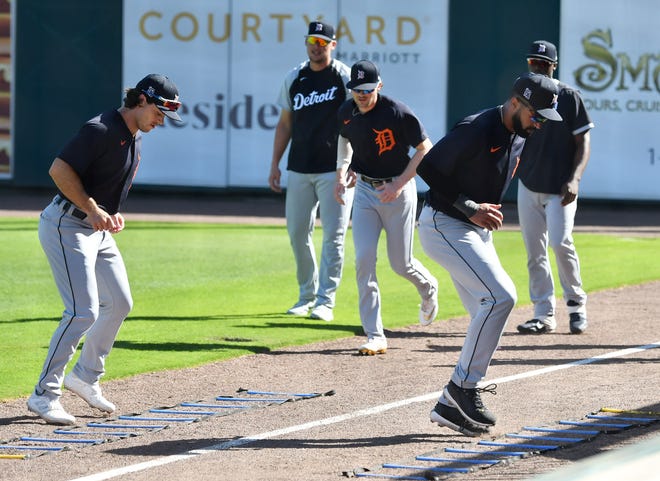 From left, Tigers non-roster invitee Jacob Robson and outfielder Derek Hill do footwork drills at the Detroit Tigers workout at Joker Marchant Stadium in Lakeland, Fla. on Feb. 27, 2021.