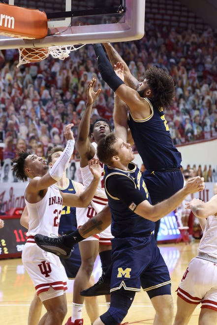 Isaiah Livers (2) of the Michigan Wolverines dunks the ball over his own teammate Austin Davis (51) during the second half.
