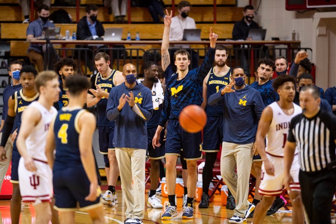 Michigan staff and players react after defeating Indiana Saturday. The Wolverines won 73-57.