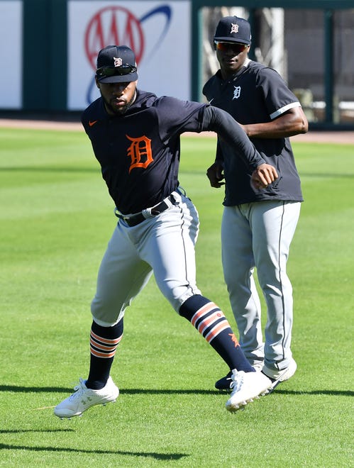 From left, Tigers outfielders Akil Baddoo and Daz Cameron warm up at the Detroit Tigers workout at Joker Marchant Stadium in Lakeland, Fla. on Feb. 27, 2021.