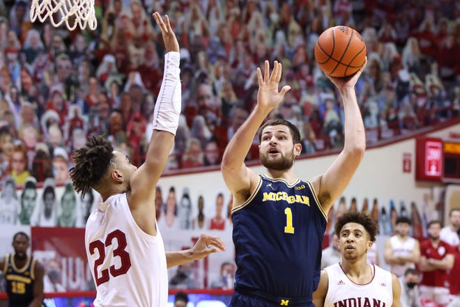 Hunter Dickinson (1) of the Michigan Wolverines shoots the ball over Trayce Jackson-Davis (23) of the Indiana Hoosiers during the second half.