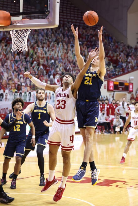Franz Wagner (21) of the Michigan Wolverines rebounds the ball over Trayce Jackson-Davis (23) of the Indiana Hoosiers during the first half.