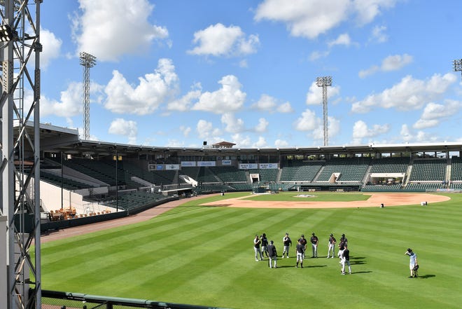 Tigers outfielders meet in the outfield at the Detroit Tigers workout at Joker Marchant Stadium in Lakeland, Fla. on Feb. 27, 2021.