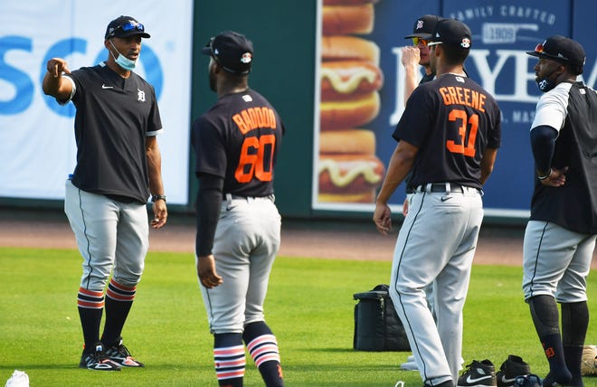 Tigers bench coach George Lombard, left, gives instructions to outfielders at the Detroit Tigers workout at Joker Marchant Stadium in Lakeland, Fla. on Feb. 27, 2021.