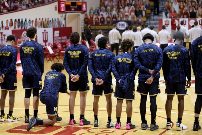 Isaiah Livers (2) of the Michigan Wolverines takes a knee during the playing of the national anthem before the game against the Indiana Hoosiers at Assembly Hall on February 27, 2021 in Bloomington, Indiana.