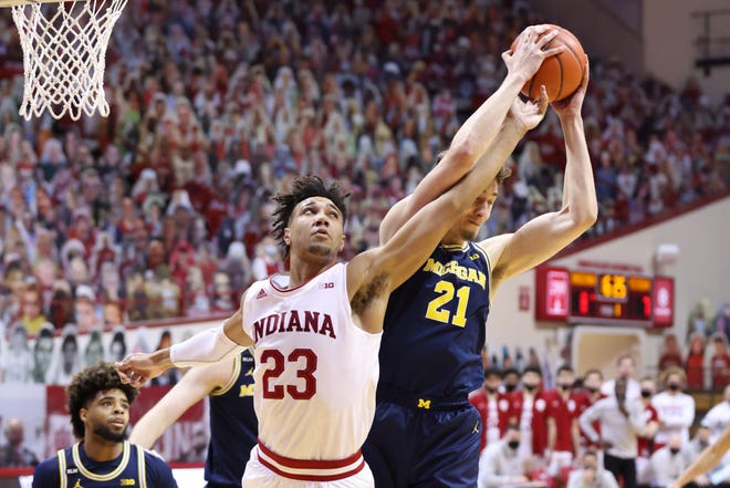 Franz Wagner (21) of the Michigan Wolverines rebounds the ball over Trayce Jackson-Davis (23) of the Indiana Hoosiers during the first half.
