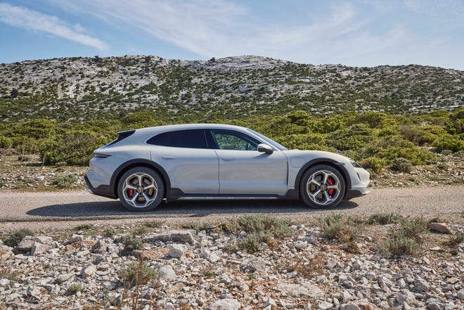 You'll know it by the black fender side-cladding. The 2021 Porsche Taycan Cross Turismo.