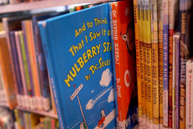 Books by Theodor Seuss Geisel, aka Dr. Seuss, including "On Beyond Zebra!" and "And to Think That I Saw it on Mulberry Street," are offered for a loan at the Chinatown Branch of the Chicago Public Library on March 02, 2021, in Chicago.