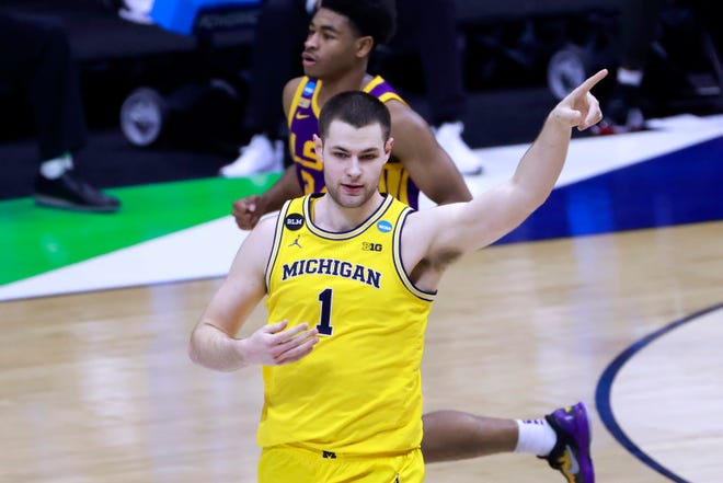 Hunter Dickinson (1) of the Michigan Wolverines gestures to a teammate during action against the LSU Tigers during the first half.