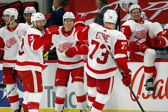 Detroit Red Wings' Adam Erne (73) celebrates his shootout goal against the Carolina Hurricanes with teammates Alex Biega (3) and Luke Glendening (41) during the third period of an NHL hockey game in Raleigh, N.C., Saturday, April 10, 2021. (AP Photo/Karl B DeBlaker)