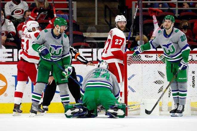 Carolina Hurricanes goaltender Petr Mrazek (34), Jordan Staal (11), and Brett Pesce (22) react following a goal by Detroit Red Wings' Valtteri Filppula (51) with Red Wings' Michael Rasmussen (27) nearby during the second period.