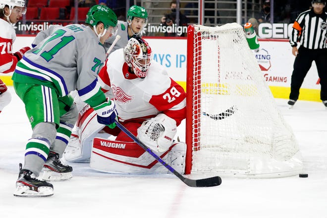 Carolina Hurricanes' Jesper Fast (71) and Detroit Red Wings goaltender Thomas Greiss (29) watch the rebounding puck during the second period.