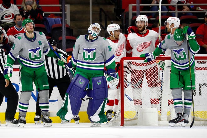 Carolina Hurricanes goaltender Petr Mrazek (34), Jordan Staal (11) and Brett Pesce (22) react following a goal by Detroit Red Wings' Valtteri Filppula (51) with Red Wings' Michael Rasmussen (27) and Dylan Larkin (71) nearby during the second period.