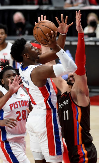 Detroit Pistons guard Hamidou Diallo, left, drives to the basket on Portland Trail Blazers center Enes Kanter, right, during the first half.