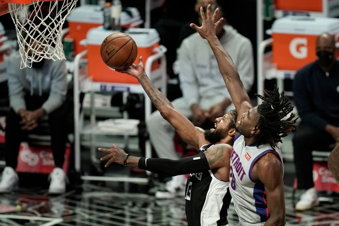 Detroit Pistons' Isaiah Stewart, right, fouls Los Angeles Clippers' Paul George during the first half of an NBA basketball game Sunday, April 11, 2021, in Los Angeles.