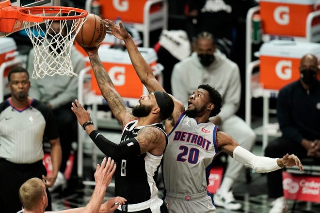 Los Angeles Clippers' Marcus Morris Sr., left, shoots under defense by Detroit Pistons' Josh Jackson during the first half.