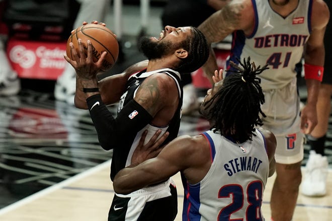 Detroit Pistons' Isaiah Stewart, right, fouls Los Angeles Clippers' Paul George during the first half of an NBA basketball game Sunday, April 11, 2021, in Los Angeles.