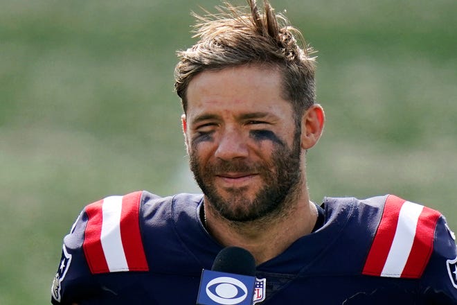 FILE—In this Sunday, Sept. 13, 2020 file photo New England Patriots wide receiver Julian Edelman gives a post-game interview after an NFL football game against the Miami Dolphins, in Foxborough, Mass.