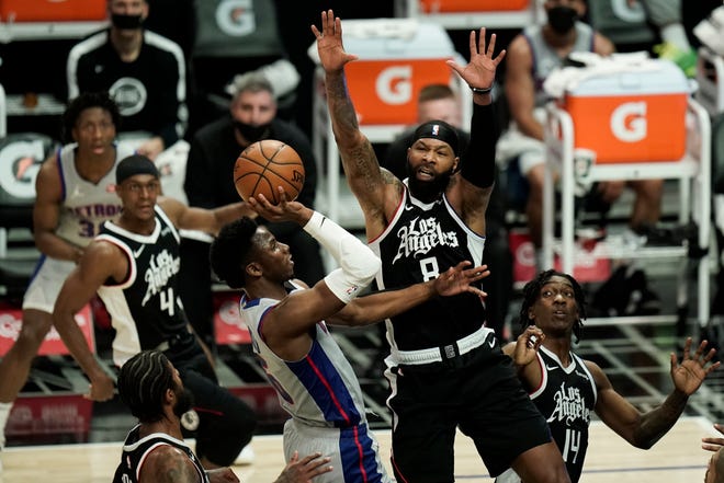 Detroit Pistons' Hamidou Diallo, center left, drives to the basket under defense by Los Angeles Clippers' Marcus Morris Sr. during the first half of an NBA basketball game Sunday, April 11, 2021, in Los Angeles.