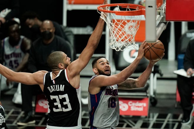 Detroit Pistons' Cory Joseph, right, goes up for a basket against Los Angeles Clippers' Nicolas Batum during the first half.
