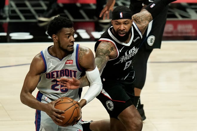Detroit Pistons' Josh Jackson, left, is defended by Los Angeles Clippers' Marcus Morris Sr. during the first half of an NBA basketball game Sunday, April 11, 2021, in Los Angeles.