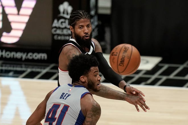 Los Angeles Clippers' Paul George, top, passes the ball under pressure by Detroit Pistons' Saddiq Bey during the second half.