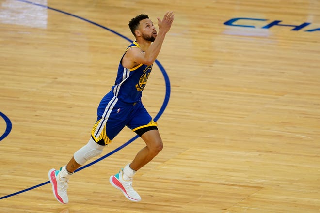 Golden State Warriors guard Stephen Curry (30) gestures after scoring against the Denver Nuggets to pass Wilt Chamberlain to become the franchise's all-time leading scorer.