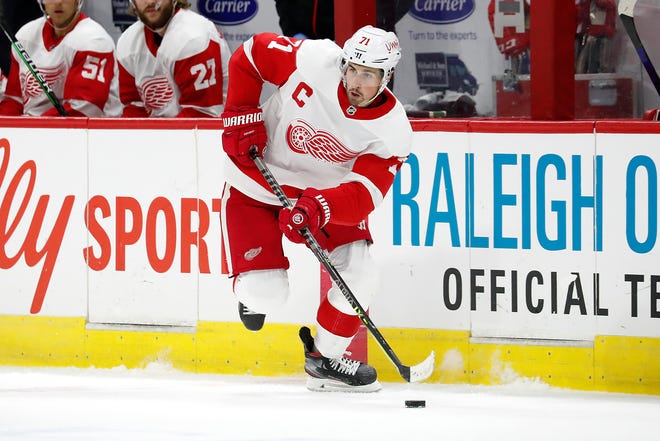 Detroit Red Wings' Dylan Larkin (71) moves the puck against the Carolina Hurricanes during the first period.