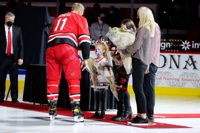 Carolina Hurricanes' Jordan Staal (11) greets his family during a pre-game ceremony recognizing his 1000 career game prior to the first period of an NHL hockey game between the Carolina Hurricanes and the Detroit Red Wings in Raleigh, N.C., Monday, April 12, 2021.