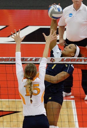 Molly Toon, right, played volleyball at Michigan from 2010-13.