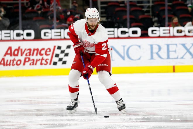 Detroit Red Wings' Michael Rasmussen (27) moves the puck against the Carolina Hurricanes during the first period.
