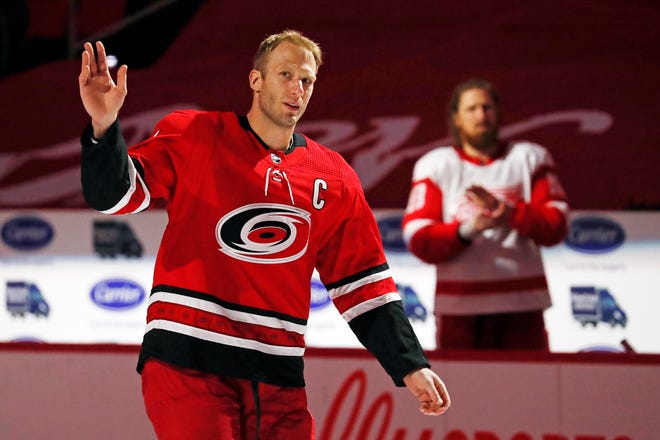 Carolina Hurricanes Jordan Staal (11) salutes the crowd with his brother Detroit Red Wings' Marc Staal (18) during a pre-game ceremony recognizing his 1000 career game prior to the first period of an NHL hockey game between the Carolina Hurricanes and the Detroit Red Wings in Raleigh, N.C., Monday, April 12, 2021.