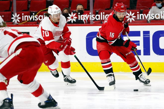 Carolina Hurricanes' Vincent Trocheck (16) controls the puck in front of Detroit Red Wings' Troy Stecher (70) during the second period.