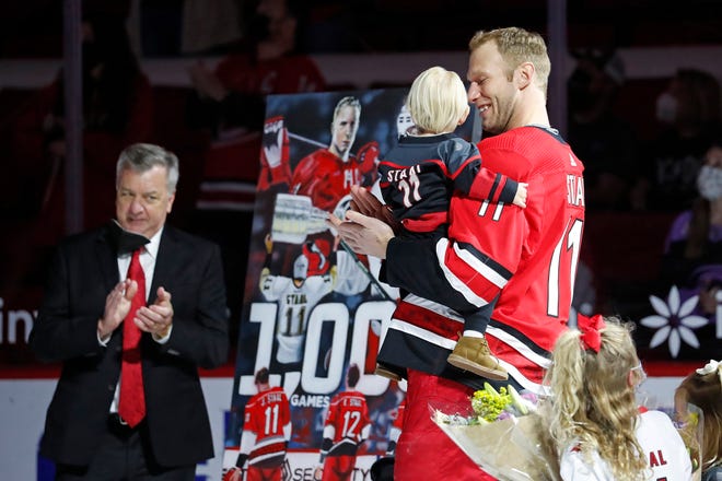 Carolina Hurricanes' Jordan Staal (11) holds his son during a pre-game ceremony recognizing his 1000 career game prior to the first period of an NHL hockey game between the Carolina Hurricanes and the Detroit Red Wings in Raleigh, N.C., Monday, April 12, 2021.