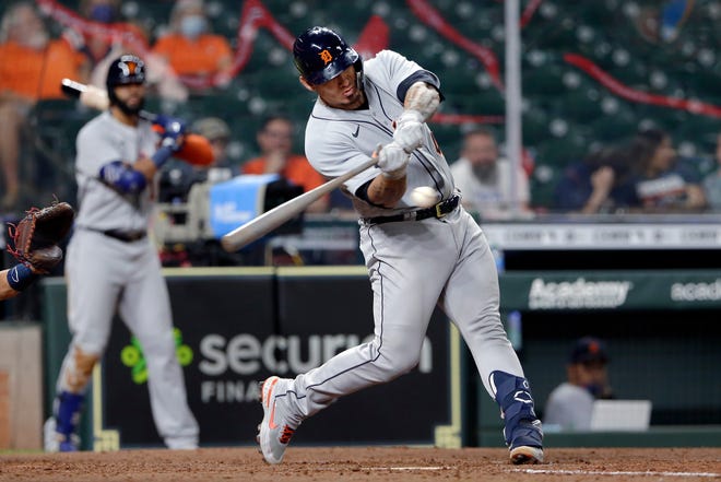 Detroit Tigers' Wilson Ramos swings on a home run during the ninth inning of the team's baseball game against the Houston Astros on Tuesday, April 13, 2021, in Houston.