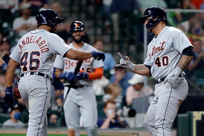 Detroit Tigers Jeimer Candelario (46) and Wilson Ramos (40) celebrate after scoring on Ramos' home run, as Nomar Mazara, middle, watches during the fifth inning of the team's baseball game against the Houston Astros on Tuesday, April 13, 2021, in Houston.