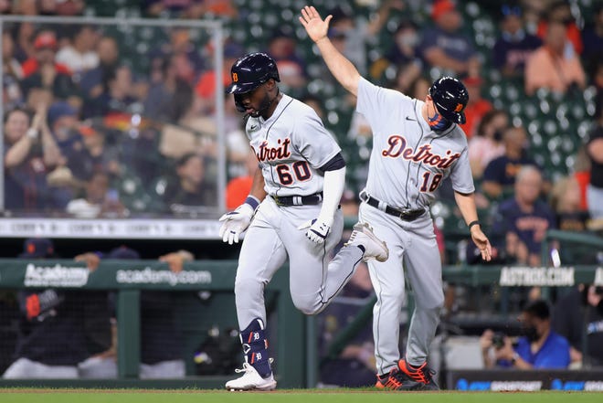 Akil Baddoo #60 of the Detroit Tigers rounds third and third base coach Chip Hale #18 after hitting a solo home run during the third inning against the Houston Astros at Minute Maid Park on April 13, 2021 in Houston, Texas.