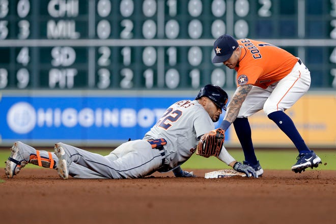 Detroit Tigers' Victor Reyes (22) is safe at second base with a double as Houston Astros shortstop Carlos Correa (1) is late with the tag during the sixth inning of a baseball game Tuesday, April 13, 2021, in Houston.