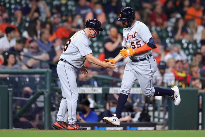 Renato Nunez #55 of the Detroit Tigers slaps hands with Chip Hale #18 after hitting a home run during the fourth inning against the Houston Astros at Minute Maid Park on April 13, 2021 in Houston, Texas.