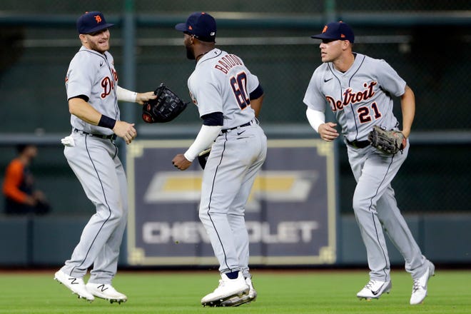Detroit Tigers outfielders Robbie Grossman, left, Akil Baddoo (60) and JaCoby Jones (21) celebrate their 6-4 over the Houston Astros to sweep the series after a baseball game Wednesday, April 14, 2021, in Houston.