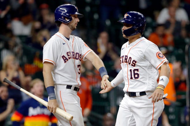 Houston Astros Kyle Tucker, left, and Aledmys Diaz (16) celebrate after Aledmys scores on the RBI single by Yuli Gurriel during the sixth inning of a baseball game against the Detroit Tigers Wednesday, April 14, 2021, in Houston.