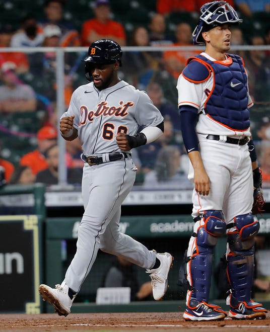 Akil Baddoo #60 of the Detroit Tigers scores on a single from Robbie Grossman #8 in the second inning against the Houston Astros at Minute Maid Park on April 14, 2021 in Houston, Texas.