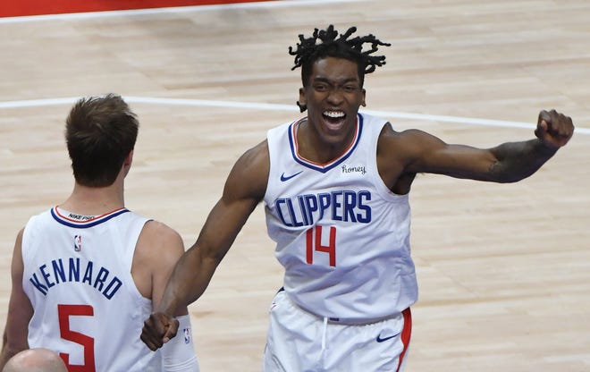 Clippers’ Terance Mann, who ended up stealing the ball away from the Pistons with the score tied and 19 seconds left in the game, begins to celebrate their victory as the clock runs out.