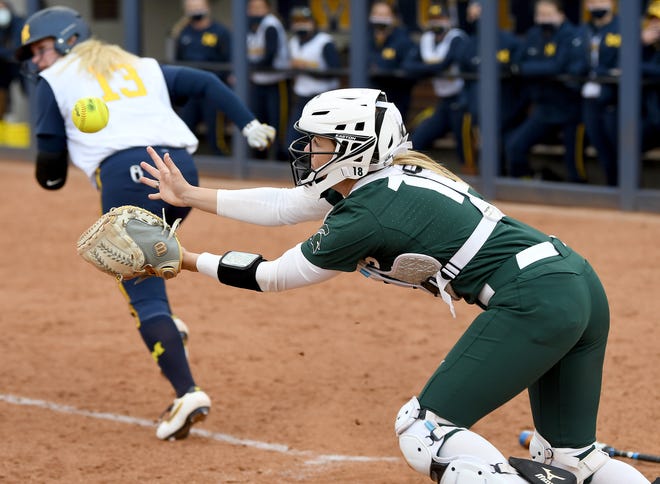 Michigan State catcher Kendall Kates makes a catch on a ball just in front of the plate off the bat of Michigan's Taylor Bump in the fifth inning of their game.