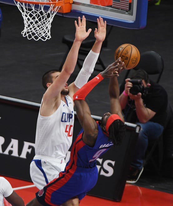 Clippers’ Ivica Zubac puts up a wall in front of Pistons’ Jerami Grant in the first quarter.
