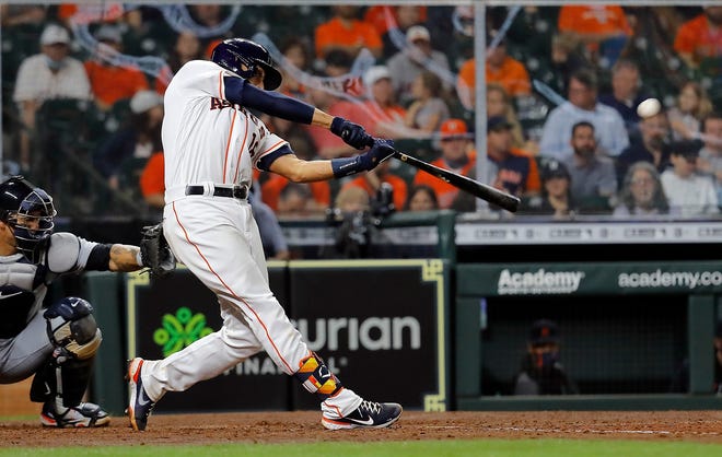 Jason Castro #18 of the Houston Astros hits a two-run home run in the fifth inning against the Detroit Tigers at Minute Maid Park on April 14, 2021 in Houston, Texas.