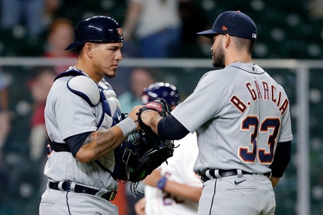 Detroit Tigers catcher Wilson Ramos, left, and closing pitcher Bryan Garcia (33) celebrate after Garcia struck out Houston Astros' Kyle Tucker with the bases loaded to win 6-4 and sweep series after a baseball game Wednesday, April 14, 2021, in Houston.