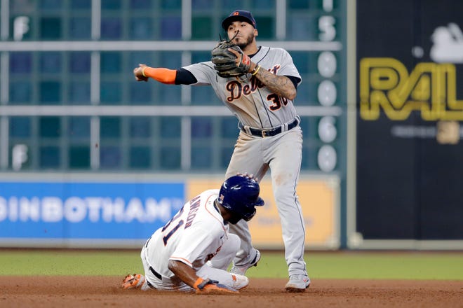 Detroit Tigers second baseman Harold Castro (30) turns a double play over Houston Astros designated hitter Ronnie Dawson, left, during the seventh inning of a baseball game Wednesday, April 14, 2021, in Houston.
