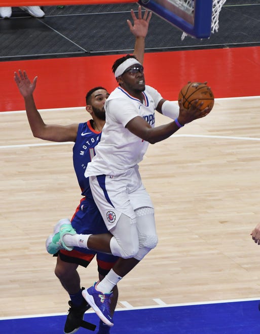 Clippers’ Reggie Jackson drives under the basket with Pistons’ Cory Joseph defending in the second quarter.